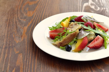 Chicken salad with fresh berries and arugula, copy space