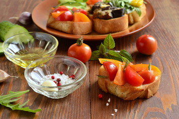 Various crostini with vegetables and herbs