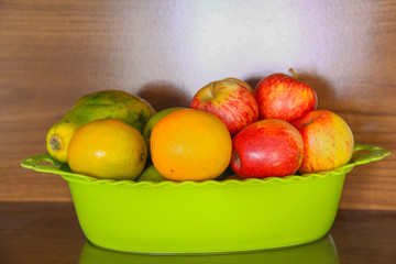 bowl with ripe fruit, apple, orange, papaya