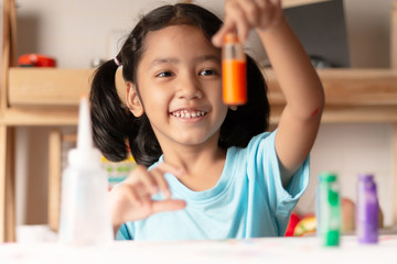 The little girl is testing color in glass