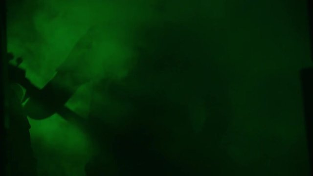 Heavy metal band playing in dark thick fog, dim green light.mov