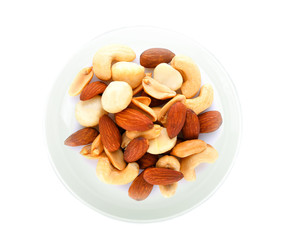 salted cocktall nuts in white plate on white background