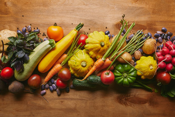 Food composition with vegetables and beans on wooden table