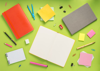 notebook and school accessories at abstract background surface