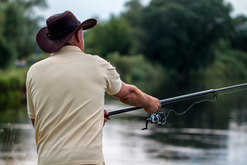 The fisherman throws the fishing rod into the water. Fishing