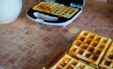 a stack Belgian waffles on a plate and in wafer