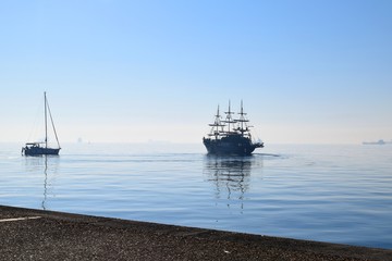 Sailing boats on Thermaikos Gulf, Thessaloniki Greece. Blue sea in mist