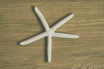 Fototapeta na wymiar Close up image of starfish on wooden table.