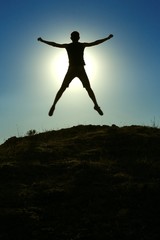 Man Jumping Against Sun