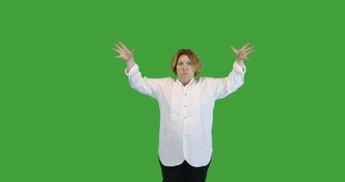 Mature woman with mind blown gesture on green screen