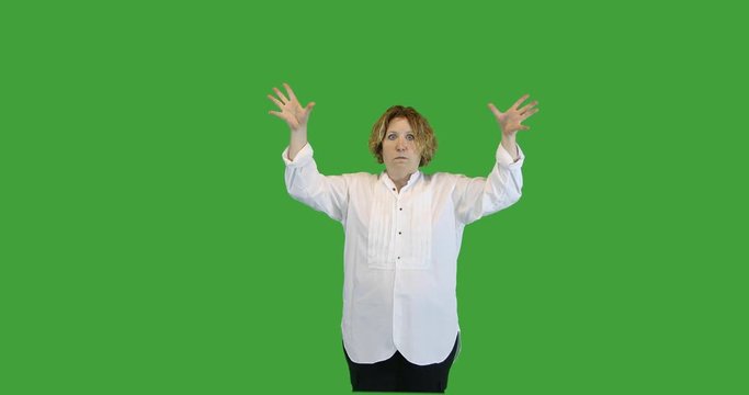 Mature woman with mind blown gesture on green screen