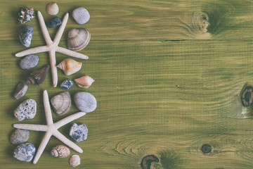 Image of starfish,seashells and stones on wooden table.