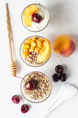 Yogurt with granola and fruit on a white background. Diet dessert.