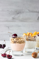 Yogurt with granola and fruit on a white background. Diet dessert.