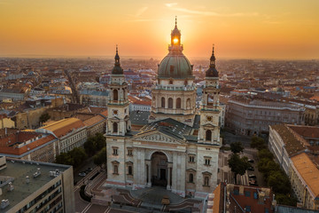 Fototapeta na wymiar Budapest, Hungary - The rising sun shining through the tower of the beautiful St.Stephen's Basilica (Szent Istvan Bazilika) at sunrise on an aerial shot