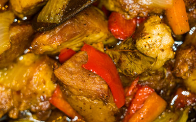 Roast meat, onions, carrots and spices, boiling in oil