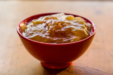 Homemade apple jamTransparent Apple sweet homemade jam in the red ceramic bowl