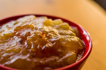Homemade apple jamTransparent Apple sweet homemade jam in the red ceramic bowl