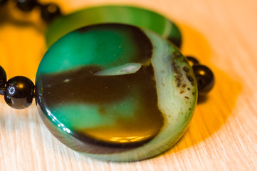 Large polished beads of beautiful translucent green agate gemstone, macro
