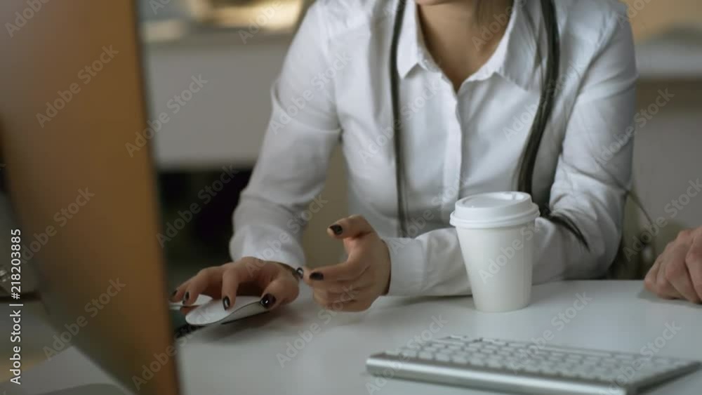 Poster handheld shot of two tired office workers, man and woman, using desktop computer when working in off