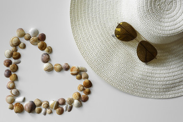 Summer fashion arrangement made from summer straw hat, aviator sunglasses and seashells from beach...