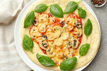 Plate with tasty pizza on table, top view
