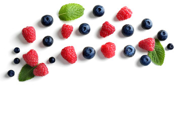 Delicious ripe berries on white background, top view
