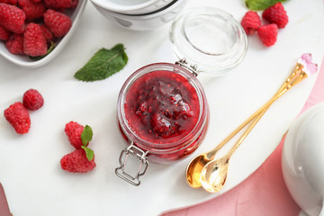 Composition with sweet homemade raspberry jam on color table