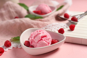 Bowl with delicious raspberry ice-cream on table