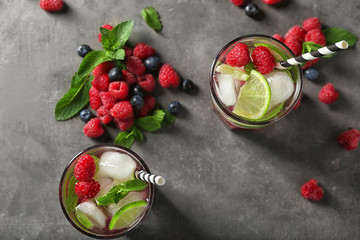 Glasses of fresh raspberry mojito on table, top view