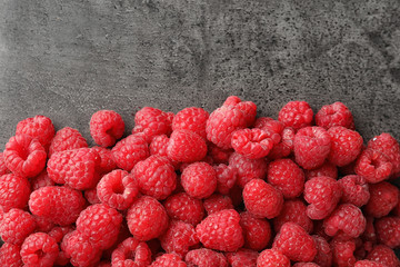 Fresh ripe raspberries on grey background