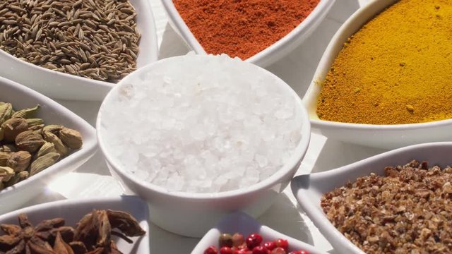 Dry spices on a rotary table. 4K. Macroshooting.