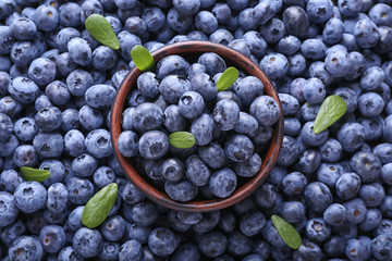 Bowl with fresh ripe blueberries, top view