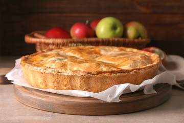 Board with delicious apple pie on table, closeup