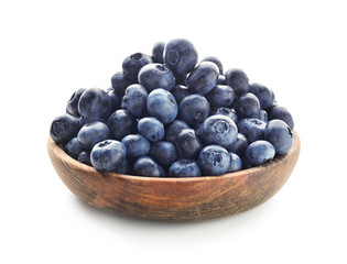 Bowl with ripe blueberries on white background