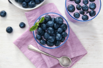 Glasses of tasty blueberry smoothie on table