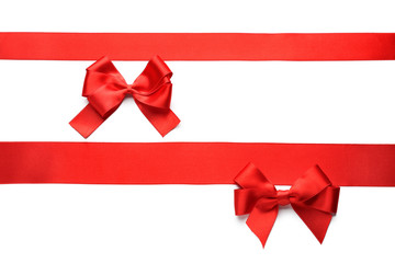 Red ribbons with bows on white background