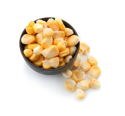 Bowl with ripe corn kernels on white background