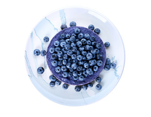 Plate with delicious blueberry cheesecake on white background, top view