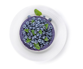 Plate with delicious blueberry cheesecake on white background, top view