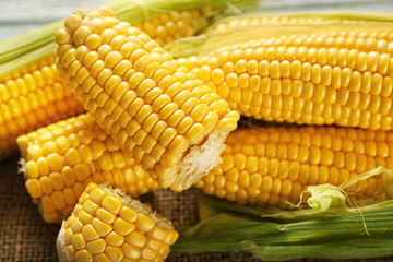 Fresh corn cobs on table, closeup