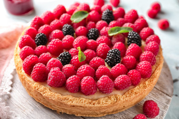 Delicious cheesecake with raspberries on table