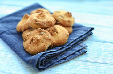 Delicious cookies with napkin on wooden table