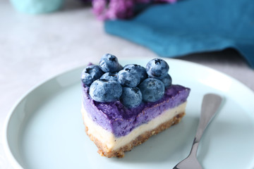 Delicious blueberry cheesecake on plate, closeup