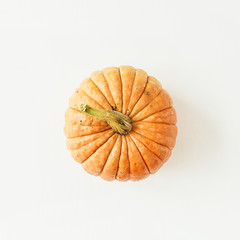 Yellow pumpkin on white background. Flat lay, top view fall autumn halloween concept.