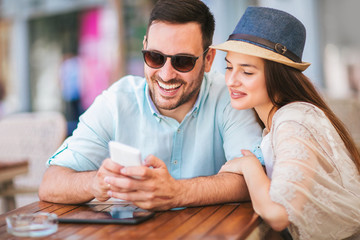 Beautiful loving couple sitting in a cafe enjoying in coffee and conversation