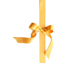 Golden ribbon with bow on white background