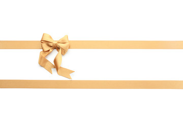 Golden ribbons with bow on white background