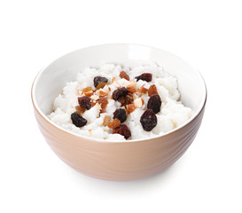 Bowl with delicious rice pudding, nuts and raisins on white background