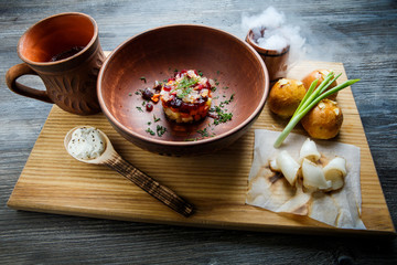 wooden table topped with plates of traditional ukrainian food